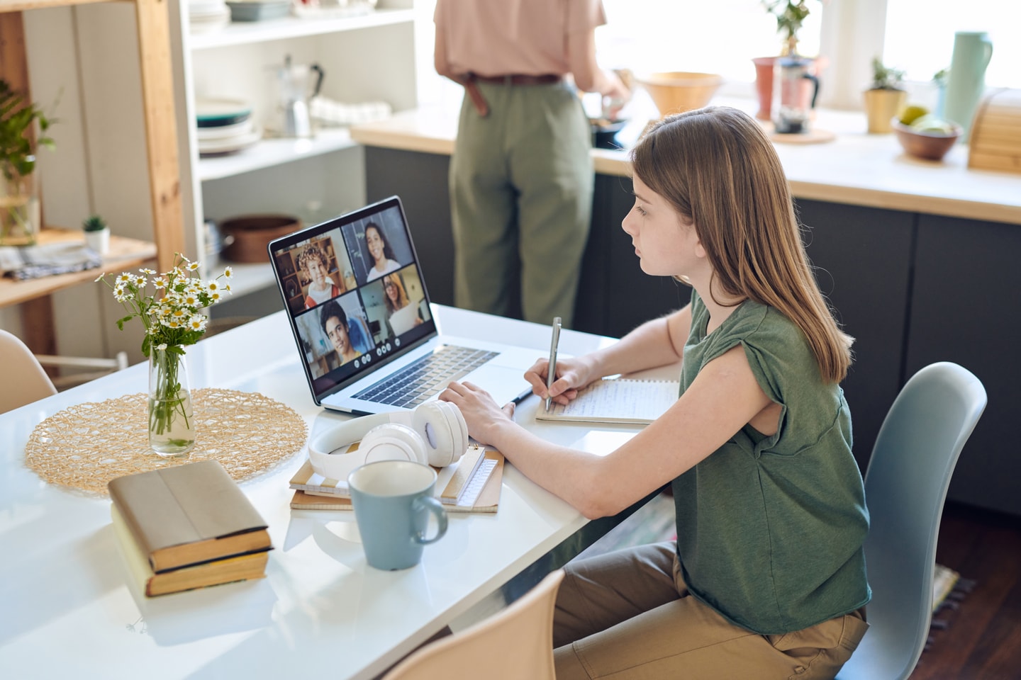 Student attending an online class on a laptop at home