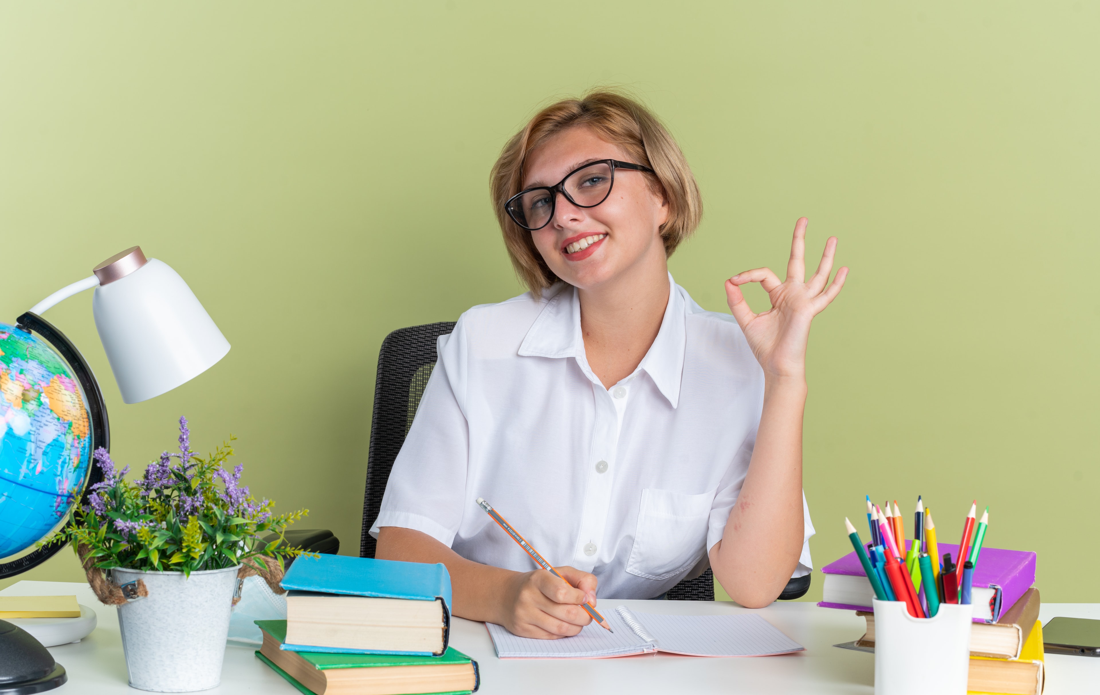 Smiling student at her desk ready to start an online class