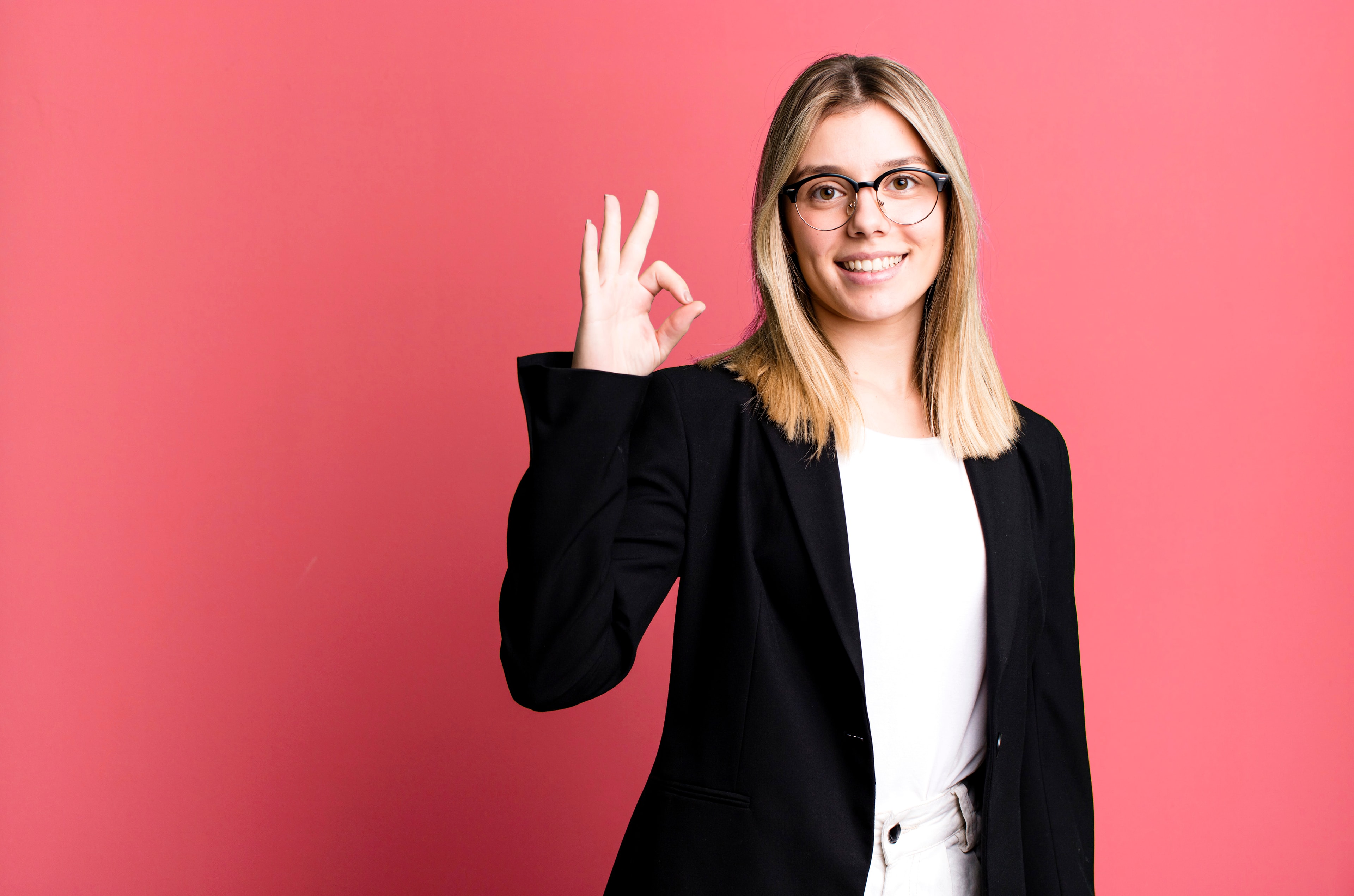 Businesswoman giving an okay gesture showing approval